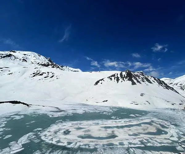 A view of snow-covered Suraj Taal in June.