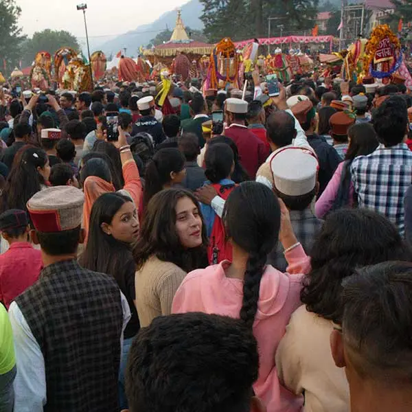 People follow the chariot of Lord Raghunath on Kullu Dussehra ground.  