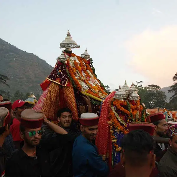 devotees carrying a deity in a palanquin in Kullu dussehra