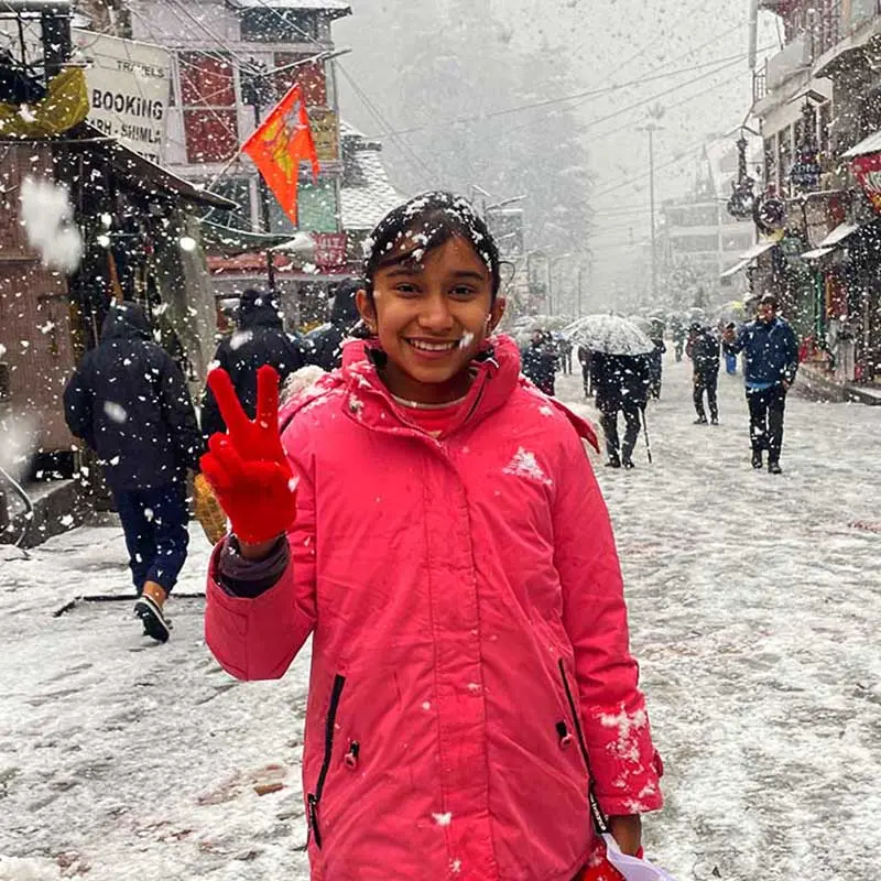 a girl in snow in Manali