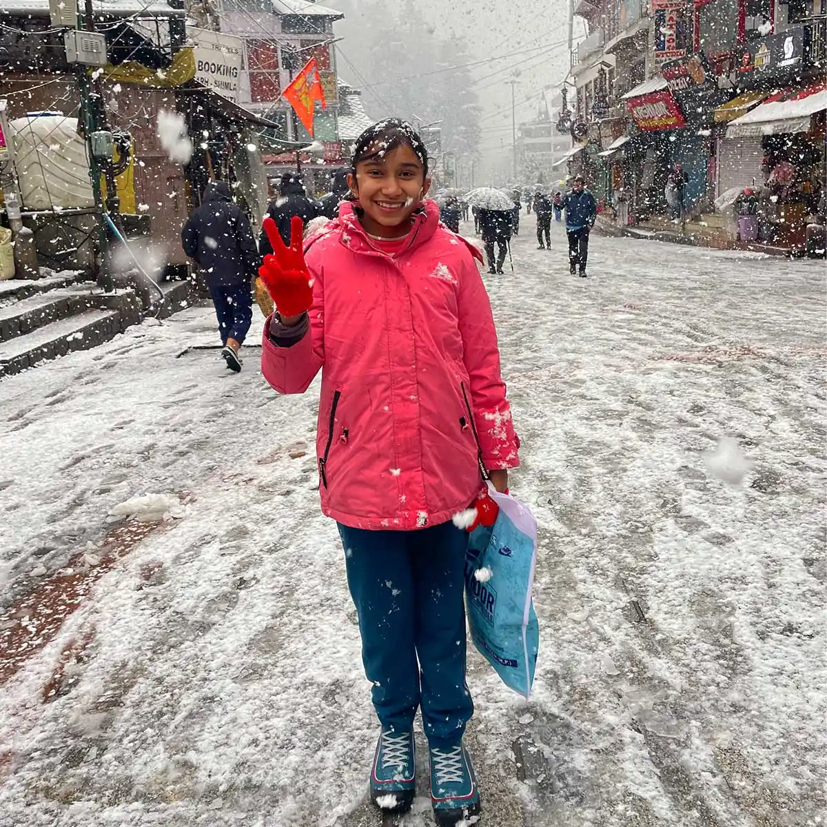 a girl posing for camera in the Manali snowfall