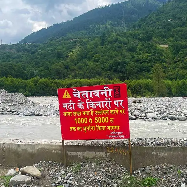 A signboard near Manali warning against going nearer to rivers. 